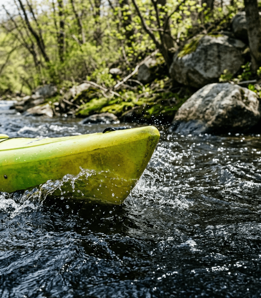 yellow kayak with water splashing over it